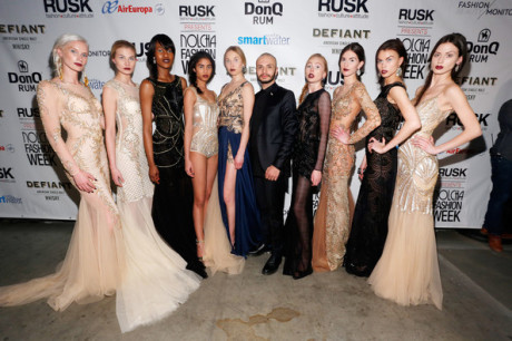 Designer Dany Tabet poses alongside models wearing dresses from his latest collection of evening wear at Nolcha Fashion Week New York on Feb. 12. Photo via zimbio.com.