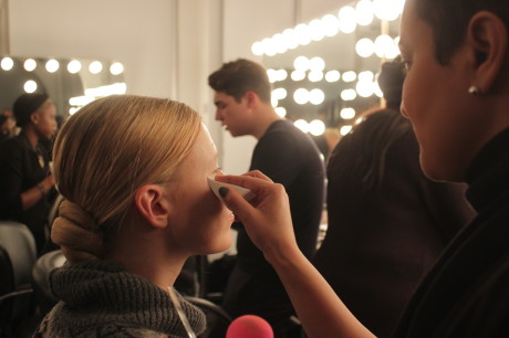 An artist applies makeup to a model backstage at Pier 59 Studios before the Fashion Palette show on Feb. 11. Photo by Chinks Doe.